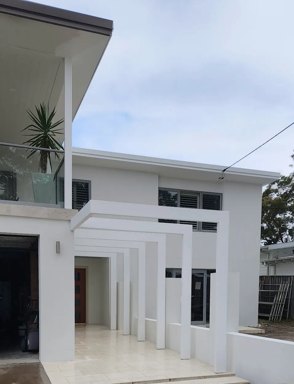 White rendered two-storey home with pillared entry