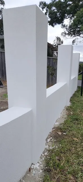 White rendered front fence pillars