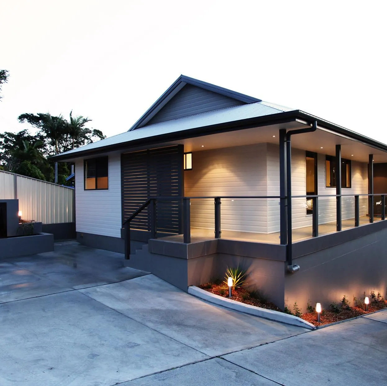 Completed rendered home lit at dusk