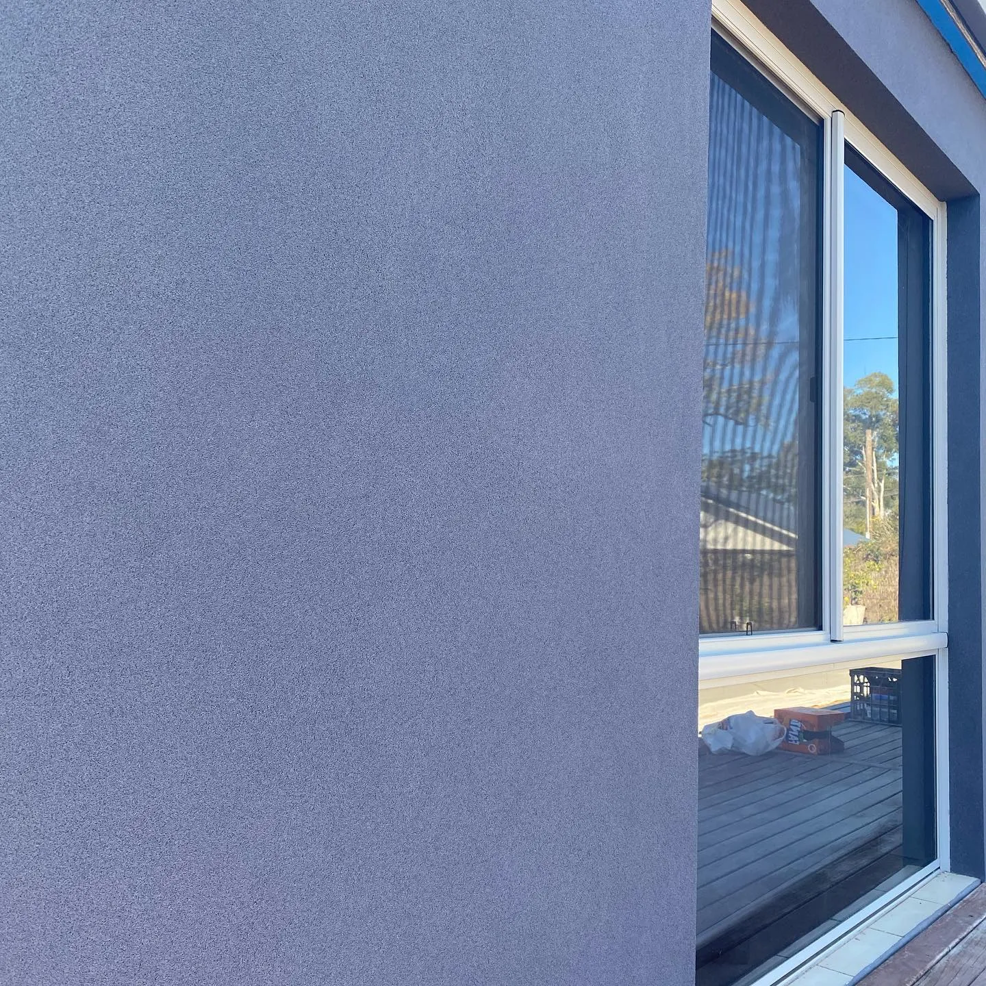 Smooth rendered wall running to a full-height window reveal