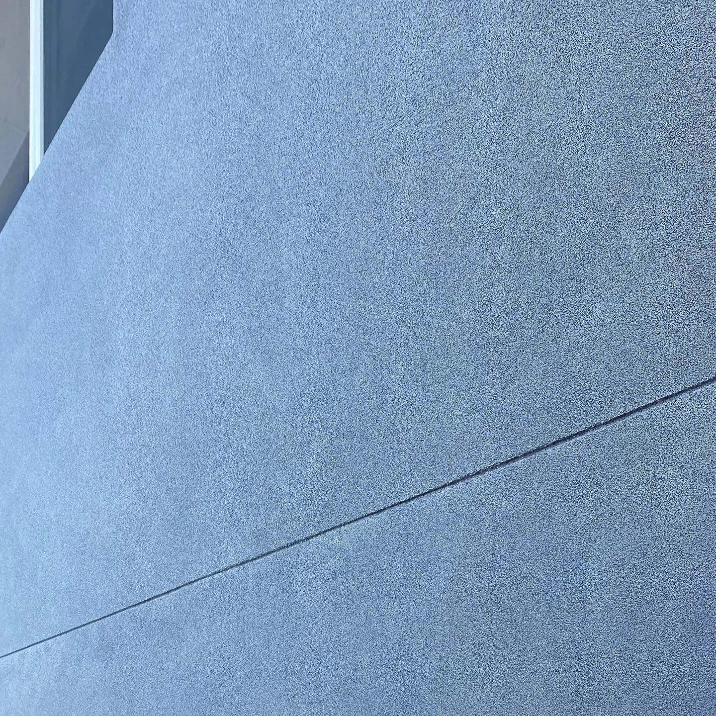 Close-up of a fine texture coating finish on a rendered wall