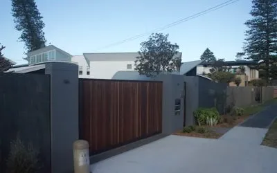 Rendered street-front wall and driveway of a coastal home